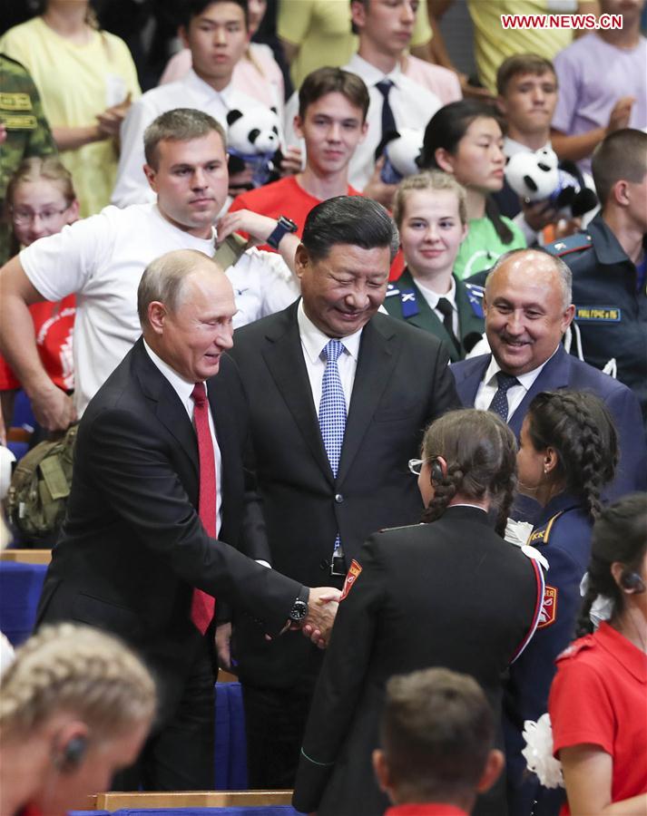 Chinese President Xi Jinping and Russian President Vladimir Putin talk with children at the All-Russian Children's Center "Ocean" while attending commemoration events marking the 10-year anniversary of the center's hosting of hundreds of Chinese children from regions hit by a deadly earthquake in 2008, in Vladivostok, Russia, Sept. 12, 2018. (Xinhua/Xie Huanchi)